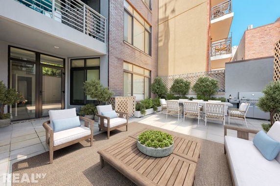 Rooftop terrace with outdoor seating and dining area.