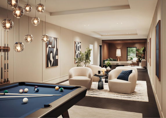 Interior view of a club house recreational room with pool table and seating area.