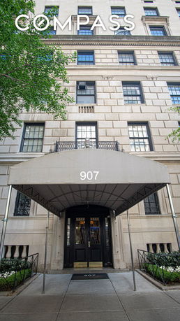Front view of a multi-story building with a covered entrance.