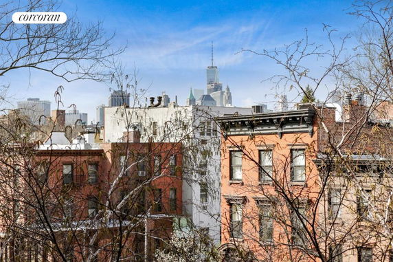 View of city buildings with trees in the foreground