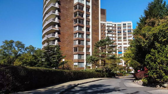 Front view of a high-rise residential building with balconies.