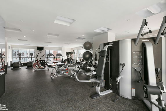 Interior view of a gym with various exercise equipment.