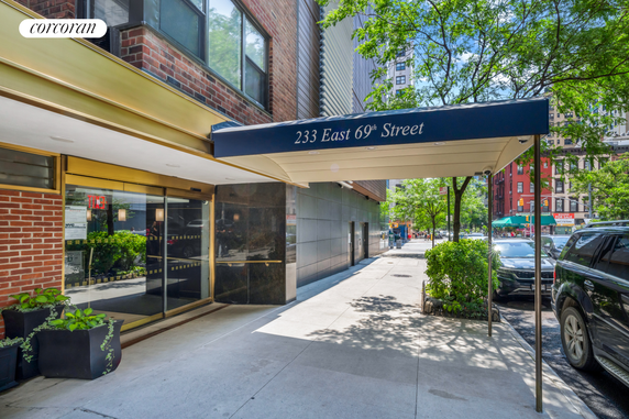 Front view of a building entrance with a canopy labeled '233 East 69th Street'.