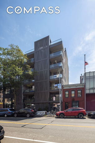 Front view of a multi-story modern building with balconies.