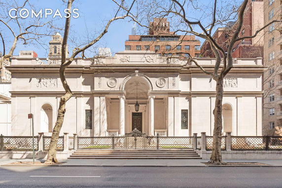 Front view of a classical building with ornate architectural details and columns.