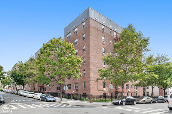 Front view of a multi-story brick apartment building.