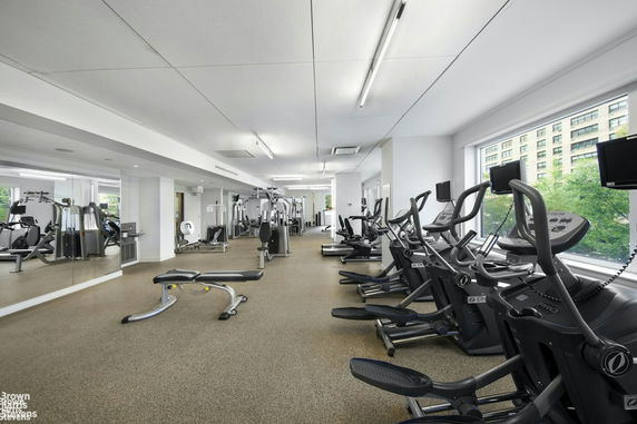 An indoor gym equipped with fitness machines and exercise equipment.