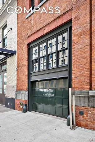 Front view of a brick building with a large garage door.