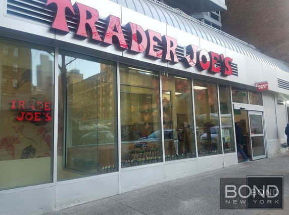 Front view of a Trader Joe's store with large glass windows and an entrance door.