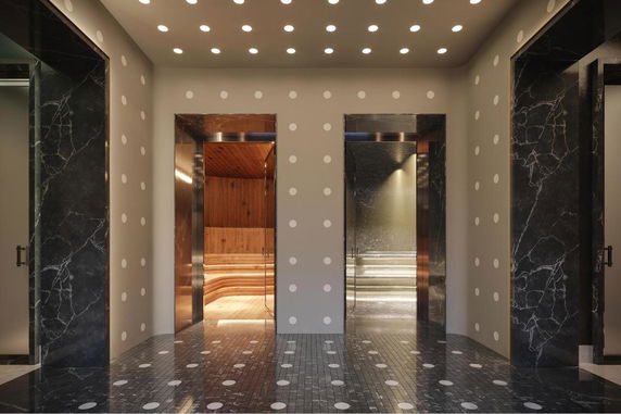 Interior view with multiple sauna rooms in a clubhouse setting.