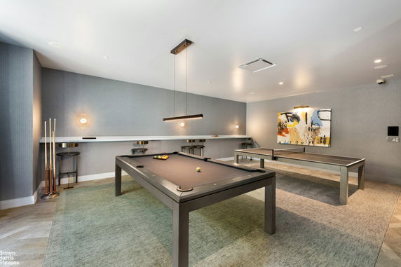 Recreational room with a billiards table and a table tennis setup.