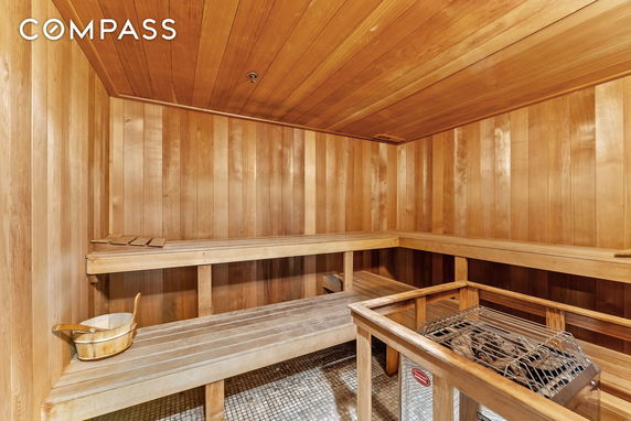Interior view of a wooden sauna room with benches.