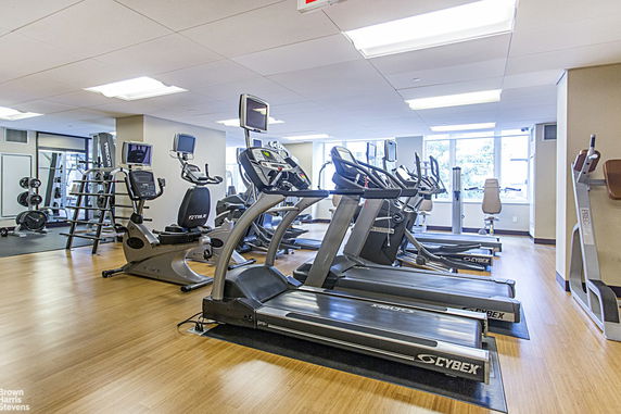 Interior view of a gym with treadmills and exercise equipment.