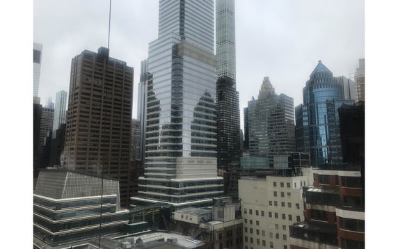 Panoramic view of multiple skyscrapers in a cityscape.