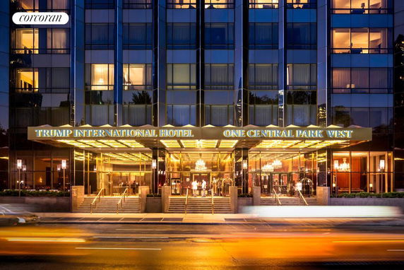 Front view of a multi-story building with a glass facade and hotel entrance.