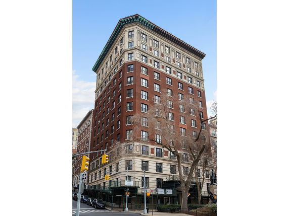 Front view of a multi-story brick building with a decorative cornice.