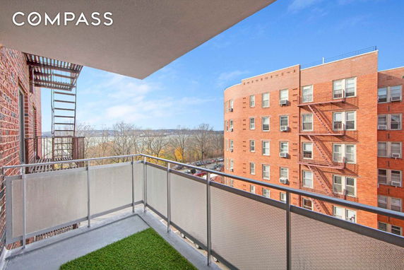 View of surrounding buildings and natural landscape seen from a balcony.