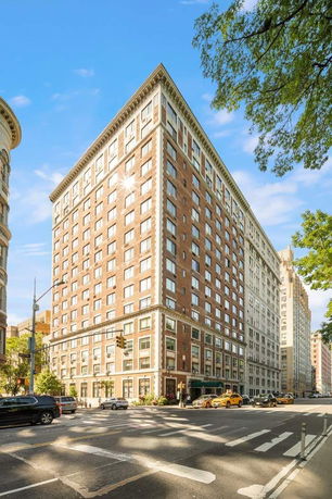 Front view of a multi-story brick building on a street corner.