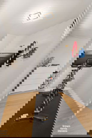 Indoor exercise area with a stationary bike and storage space.