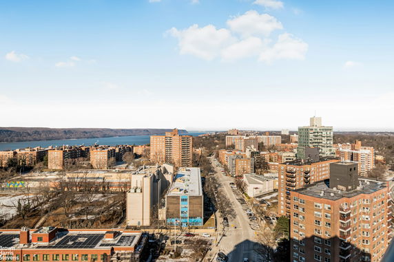 Panoramic view of urban buildings with a river in the background.