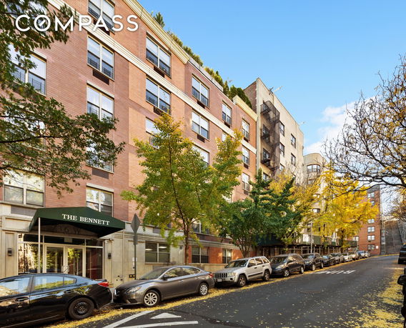 Front view of a multi-story building with a brick facade.
