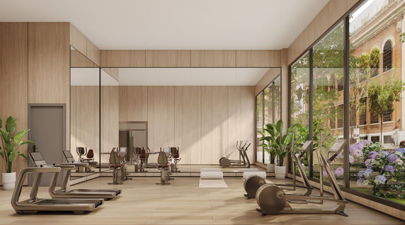Indoor gym area with modern exercise equipment and large windows.