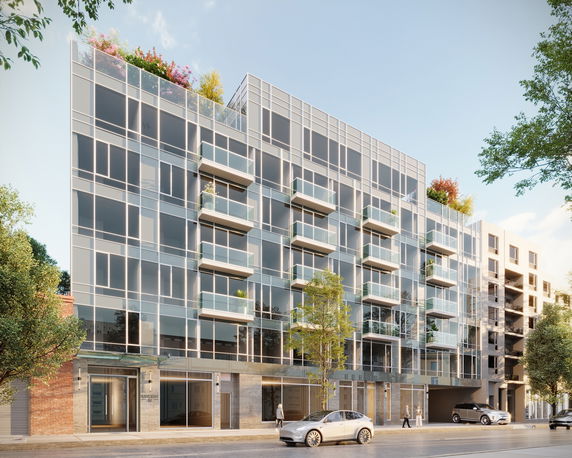 Front view of a modern multi-story glass facade building with balconies.