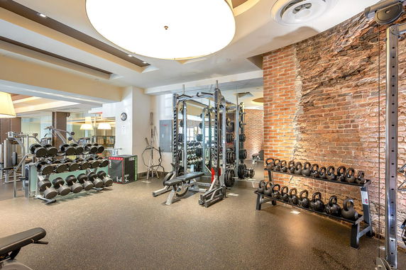 Indoor gym area with exercise equipment and weights
