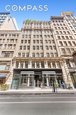 Front view of a multi-story building with ornate architectural details.
