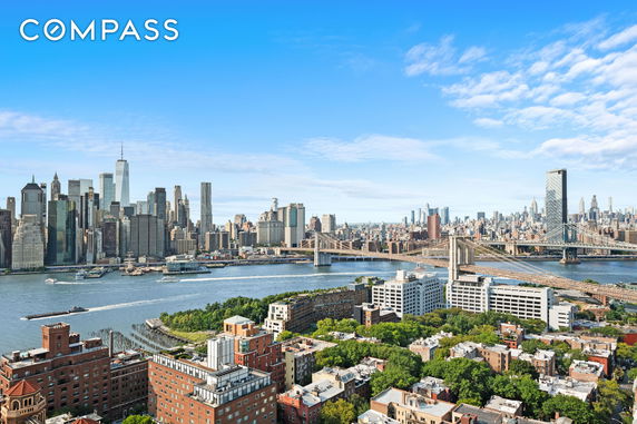 Wide-angle view of a city's skyline with river and bridges.