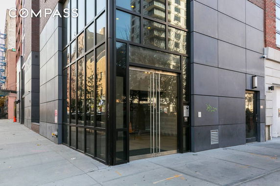 Front view of a modern building with large glass entrance.