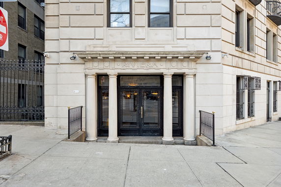 Front view of a building entrance with decorative columns and the name 'Riviera' above the doorway.