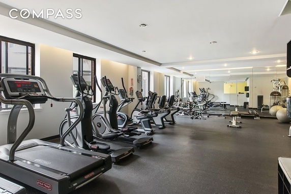 Interior view of a spacious gym area with exercise equipment.