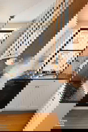 Front view of a large white building with a modern design and multiple floors.