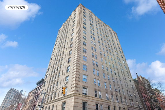 Front view of a tall multi-story building with numerous windows.