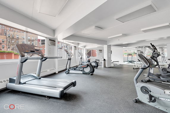 Interior of a gym with treadmills and exercise equipment.