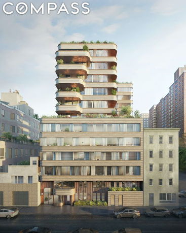 Front view of a multi-story modern residential building with curved balconies and greenery.