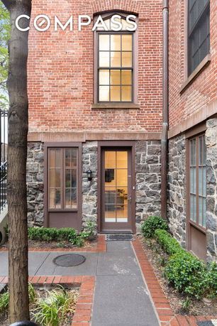Front view of a house with a brick and stone facade.