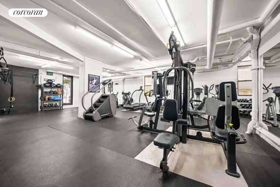 Indoor gym area with exercise equipment and workout stations.