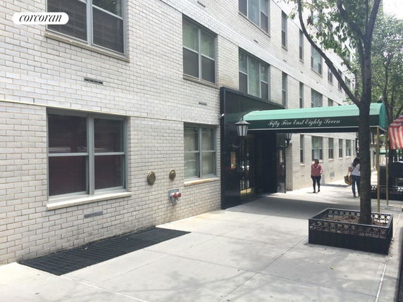 Front view of a multi-story building with an entrance canopy.