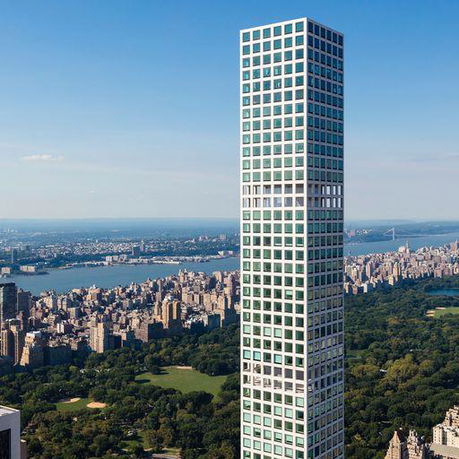 Tall skyscraper with a grid-like facade overlooking a cityscape and park