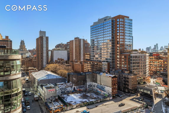 Panoramic view of a cityscape with multiple high-rise buildings and urban surroundings.