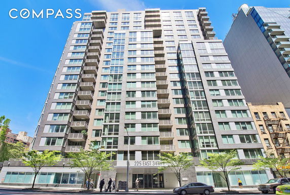 Front view of a multi-story residential building with balconies and large windows.