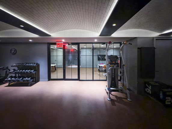 Indoor area with gym equipment and glass doors.