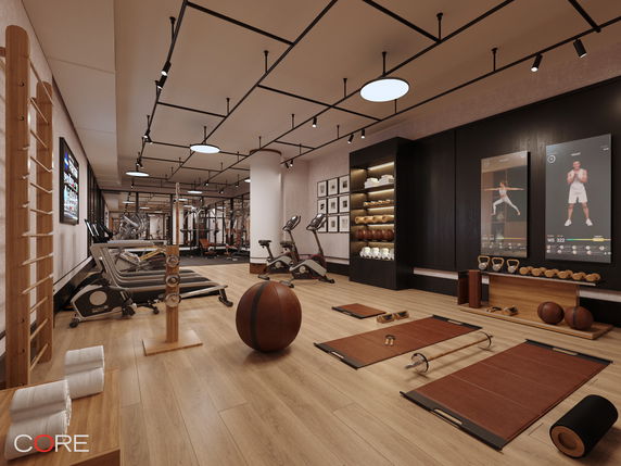 Interior view of a gym with exercise equipment and workout mats.