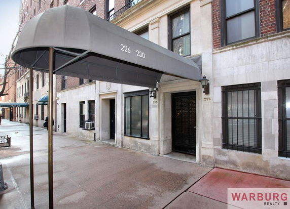 Front view of a building entrance with an awning.