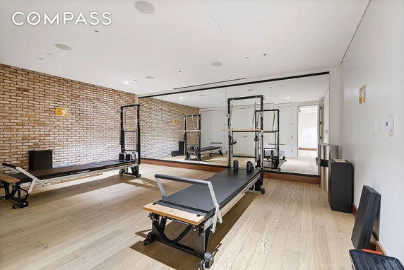 Indoor fitness room with exercise equipment and mirrors.