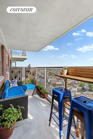 Balcony view with seating and table looking out over the city.