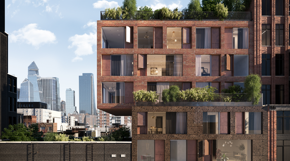 Front view of a multi-story brick building with large windows and terrace garden.