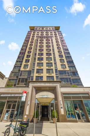 Front view of a tall, multi-story building with a modern facade.